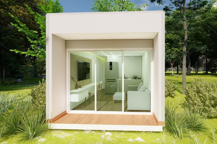 Módulo branco com grande vão envidraçado, instalado num terreno arborizado.